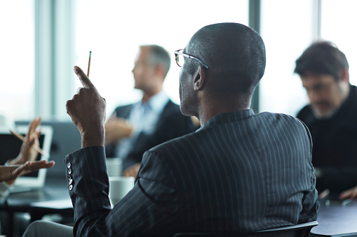 Business people in large modern meeting room