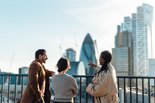 Group of business people looking at London skyline