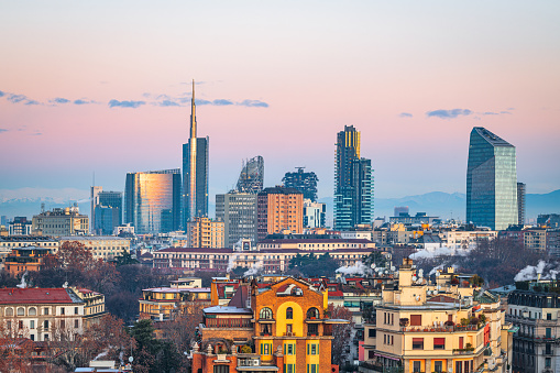 Milan, Italy financial district skyline over residential apartments at dawn.