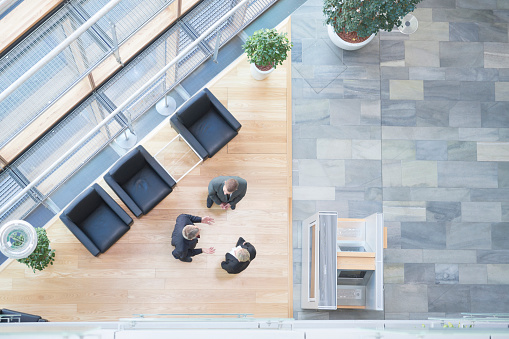 Three business people talking in modern office