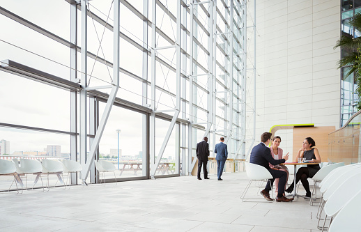 Group of business people meeting in a foyer of a modern building