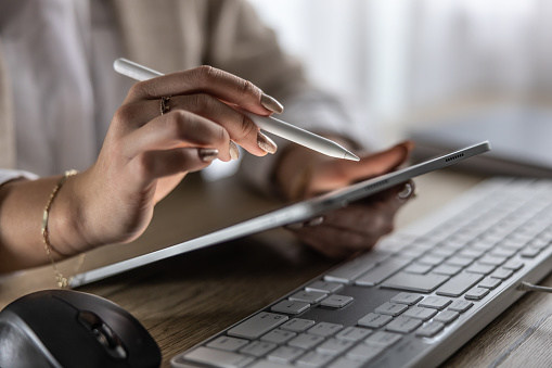 Woman hands holding stylus and tablet